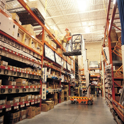 15-Foot Push-A-Round Lift in Warehouse – Image of a 15-foot push-around lift fully extended in a warehouse setting. The lift boasts a blue and white design with a secure platform and safety guardrails. It features a sturdy wheeled base for easy movement. Ideal for reaching high shelves, maintenance tasks, and inventory management in industrial environments.